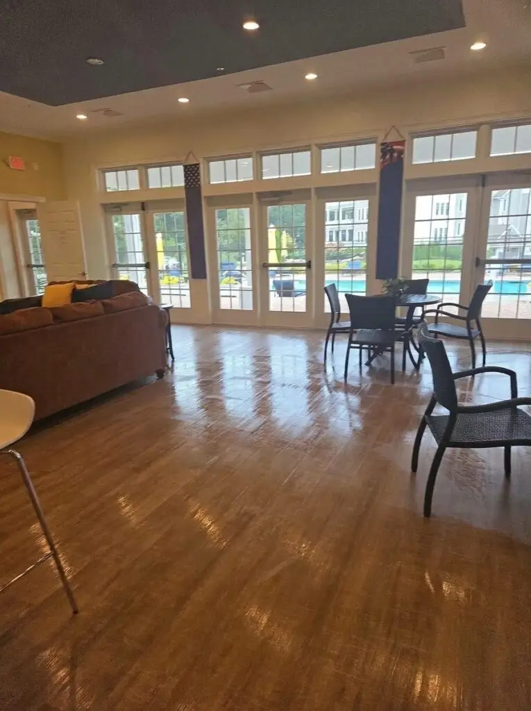 Clean clubhouse living area with shiny wood floors